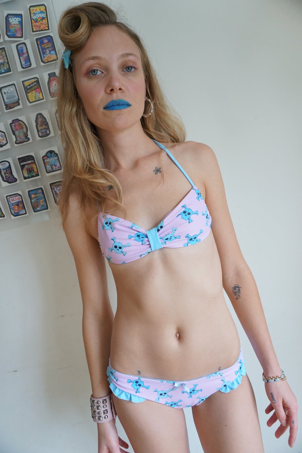 girl wearing pink bikini with blue skull pattern