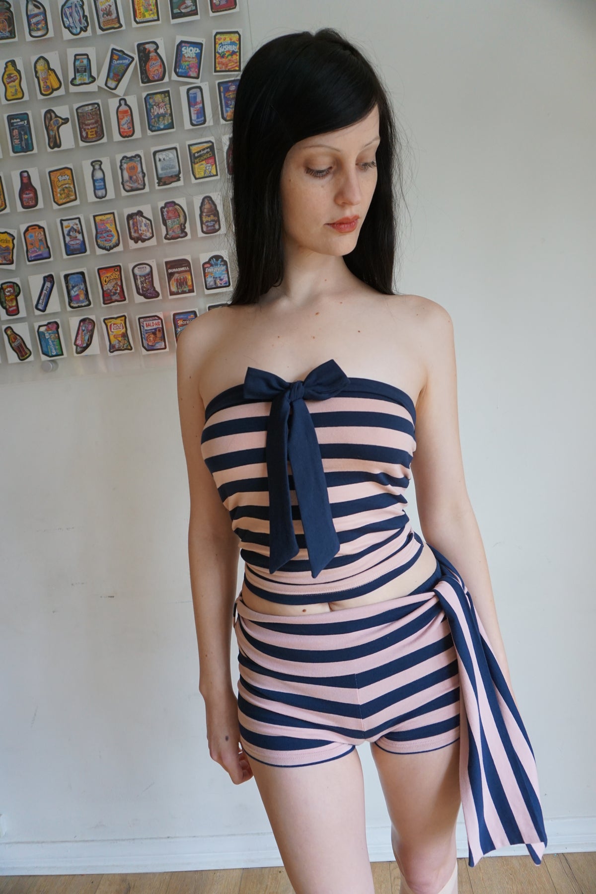 Woman wearing a pink and navy blue tube top and shorts set