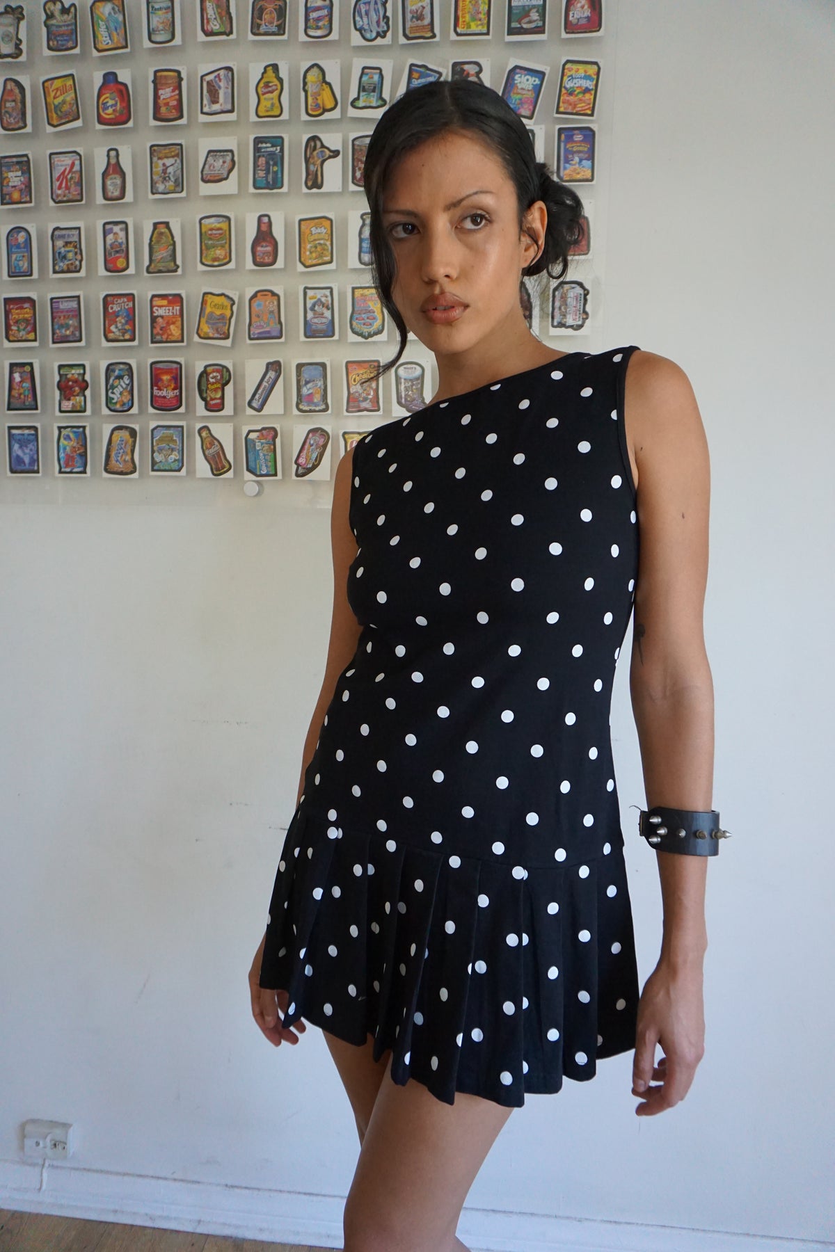 Girl wearing a drop waist black and white polka dot dress