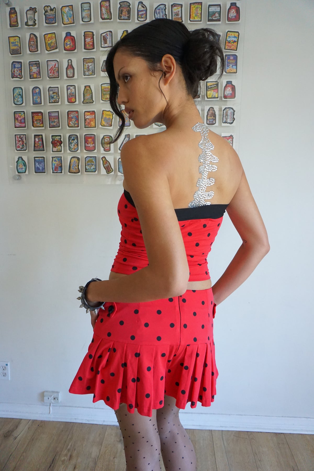 pleated red skirt with black polka dots and buttons on the side