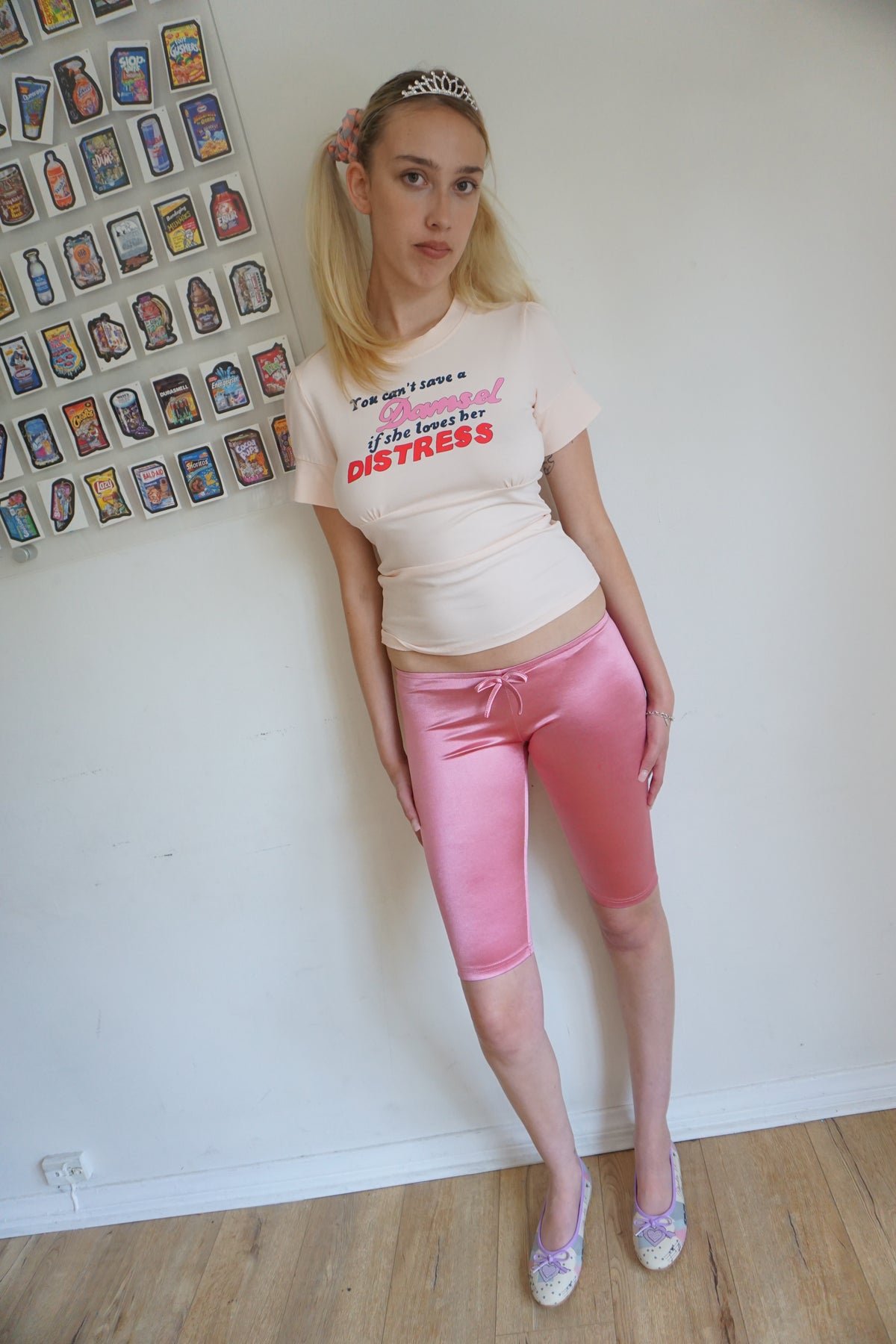 Girl wearing satin pink capris with a bow and a graphic t shirt