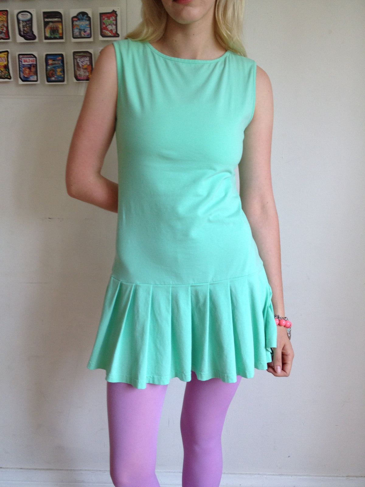 girl wearing a mint green drop waist pleated dress