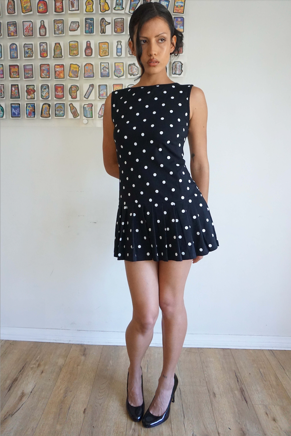 Girl wearing a drop waist black and white polka dot dress